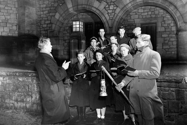 Carol singers rehearsing outside Reid Memorial Church in Edinburgh.