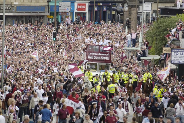 The Hearts team is welcomed back to Edinburgh by thousands of Jambos after beating Gretna in the Scottish Cup final in 2006. The team is pictured on an open top bus with the trophy at Haymarket on route to their home in Gorgie.