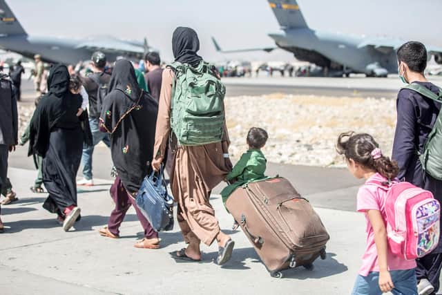 Desperate refugees queue to board a US military plane at Kabul airport