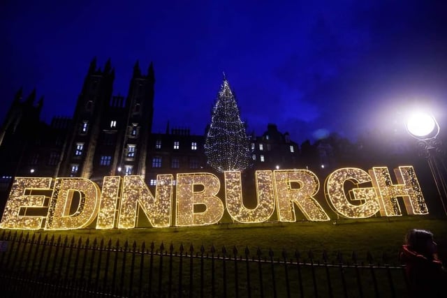 Edinburgh's giant Christmas sign looks over the city and sits beneath the Castle's magical light display.