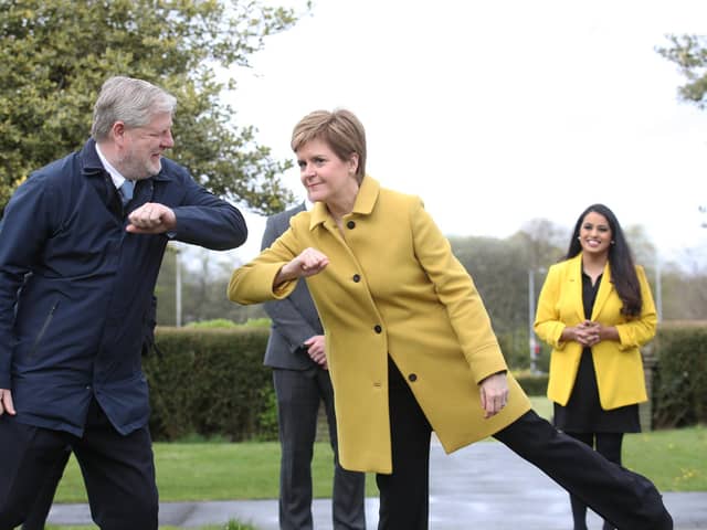 Nicola Sturgeon and Angus Robertson greet each other during a visit to Airdrie on Sunday (Picture: Andrew Milligan/pool/Getty Images)