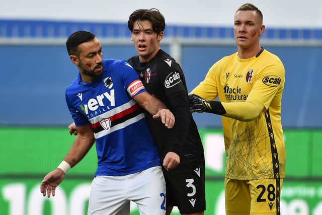 Aaron Hickey gets to grips with veteran striker Fabio Quagliarella during a Serie A match between Bologna and Sampdoria
