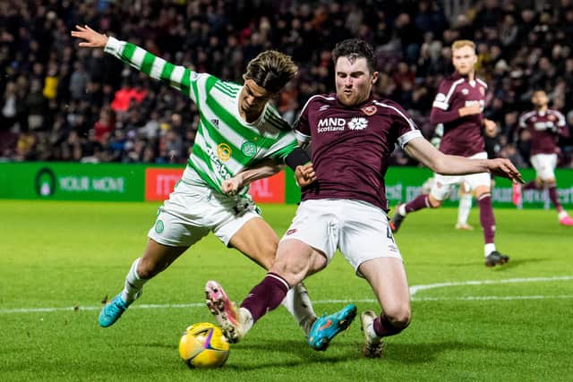 Hearts defender John Souttar in a tussle with Celtic winger Jota.