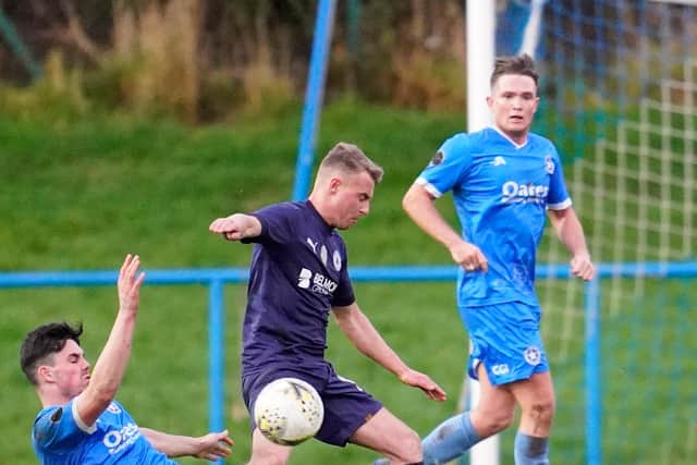 Typifying his team's fighting spirit, Newtongrange forward Ryan Porteous makes a determined challenge for the ball against Musselburgh