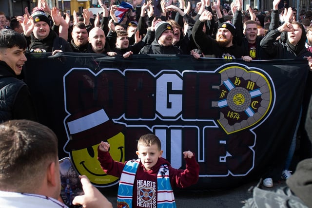 A young fan joins in the march to Tynecastle.