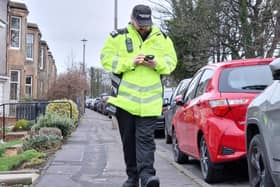 Parking attendants enforcing the pavement parking ban in Edinburgh