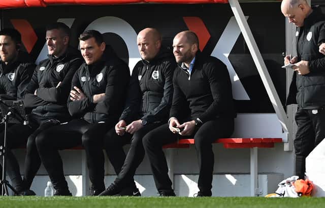 Hearts manager Robbie Neilson and his coaching staff look on at Pittodrie.