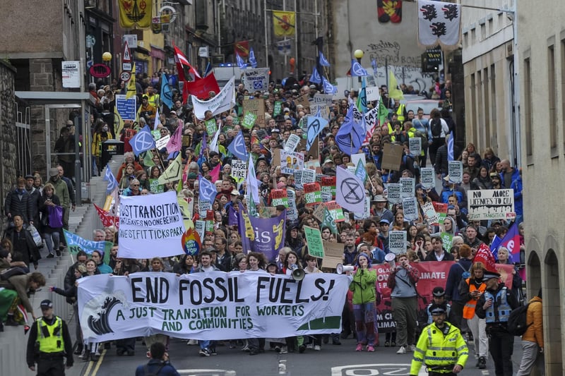 End Fossil Fuels Scotland demonstrators held a protest in Edinburgh yesterday. Marching from the Mound to the Scottish Parliament. Here they are pictured marching down the Royal Mile towards Holyrood.