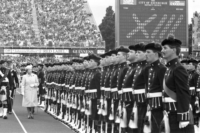 Queen Elizabeth II reviews her guard of honour at the closing ceremony of the Edinburgh Commonwealth Games 1986.