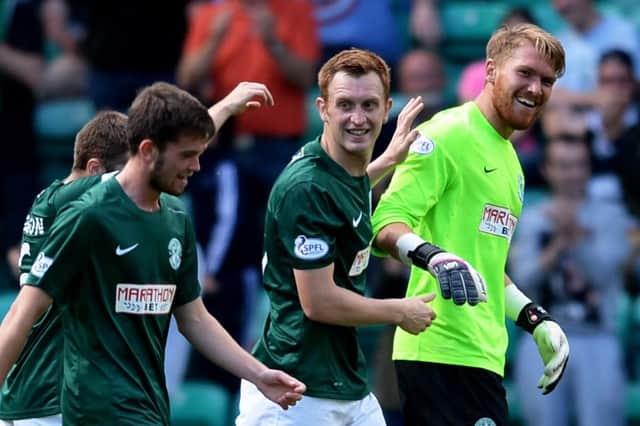 Hibs team-mates celebrate with Mark Oxley after the goalkeeper scored in a victory over Livingston on opening day in 2014. Picture: SNS