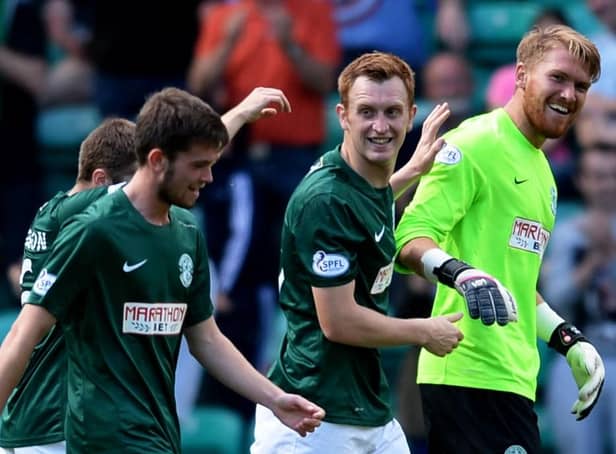 Hibs team-mates celebrate with Mark Oxley after the goalkeeper scored in a victory over Livingston on opening day in 2014. Picture: SNS