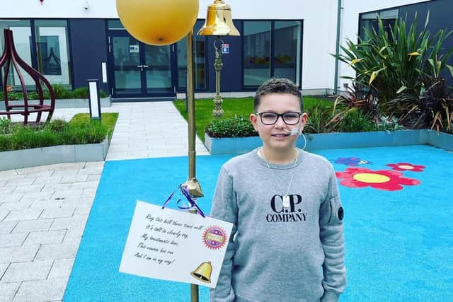 Leo Barker rings the bell to mark the end of treatment for cancer