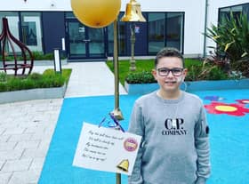 Leo Barker rings the bell to mark the end of treatment for cancer