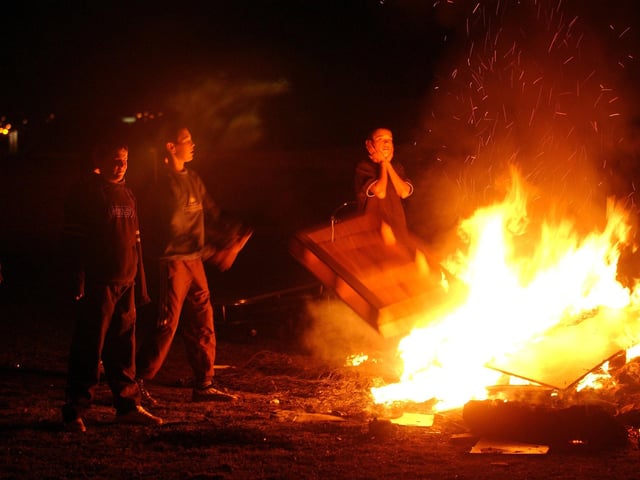 Kids around the bonfire on the Broomhouse Estate in Edinburgh, 2003.