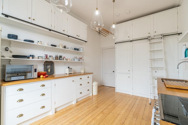 The large kitchen comes with plenty of storage in the form of base and wall units, open shelving and fitted cupboards. A quirky and fun feature is the sliding ladder which provides access to the higher level storage.