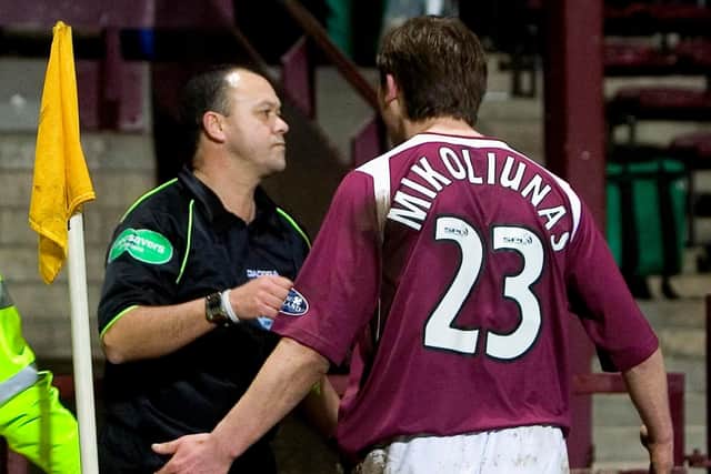 Saulius Mikoliunas bumps linesman Andy Davis after a controversial penalty call, earning a red card and a five-game ban. Picture: SNS