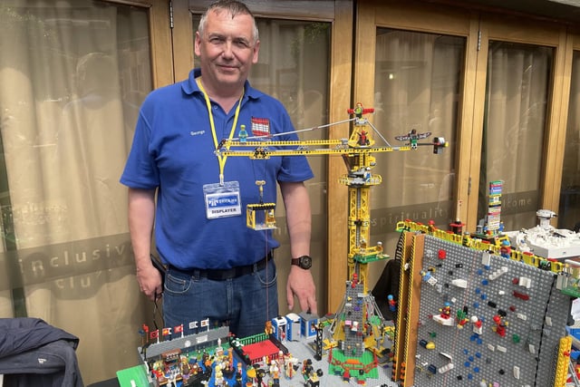 George Colvan with his model of a climbing and activity centre which showed people on a climbing wall, a large crane and even people drinking at the pub.