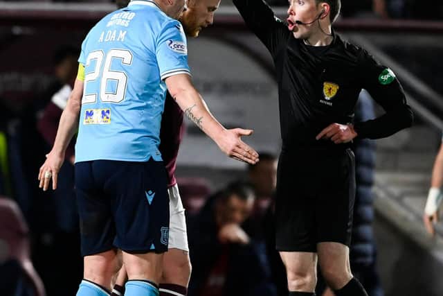 Dundee's Charlie Adam receives a yellow card for dissent