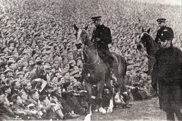 Mounted police keep an eye on the crowds at Easter Road after a 'break in' (the gates had been closed 15 minutes before the start) at an Edinburgh derby Hibs v Hearts football match in January 1950. A record attendance of more than 65,000 fans saw Hearts win the match 1-2.