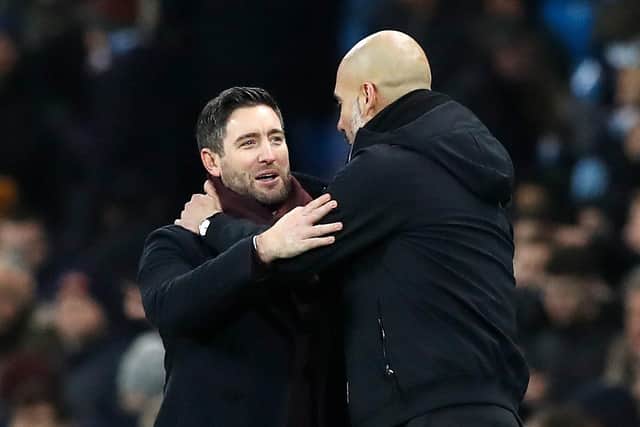 Johnson (left) with Manchester City manager Pep Guardiola after the Carabao Cup semi-final first-leg match at the Etihad Stadium in January 2018