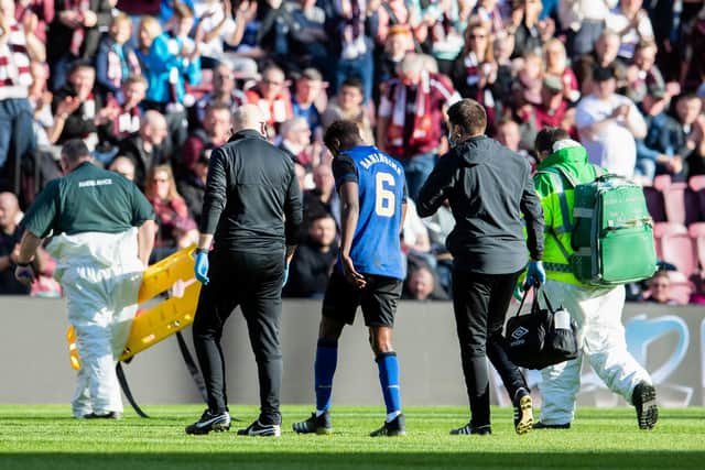 Hearts midfielder Beni Baningime limped off with a knee injury on Saturday.
