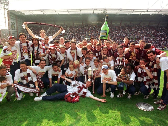 Hearts acknowledge all their fans after showing off the Scottish Cup on a glorious sunday at Tynecastle Park in 1998.  Included in the celebrations are the Hearts BP Youth Cup winners too.
