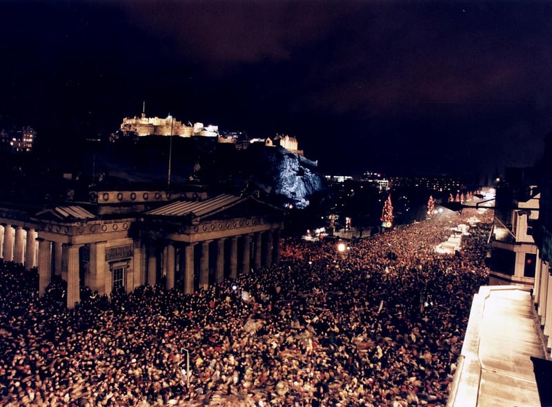 Revellers celebrating New Year on Princes street at The Mound with Edinburgh Castle in the background. There were a reported 400,000 people in attendance.