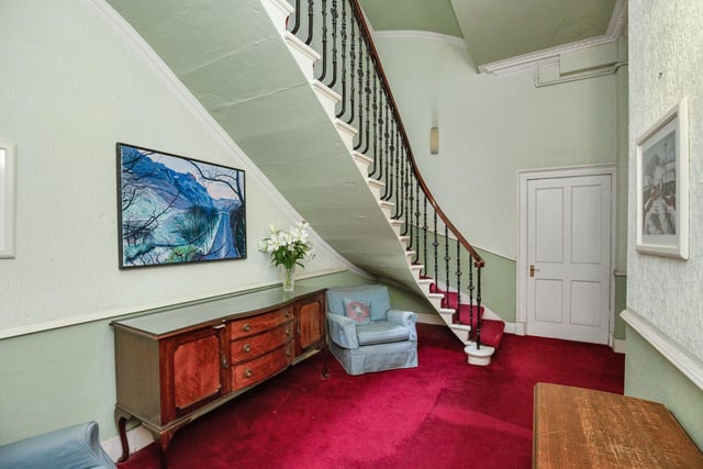 The first-floor flat is accessed by a grand staircase.