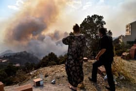 A wildfire rages in the forested hills of the Kabylie region, east of the Algerian capital Algiers, earlier this month. Dozens of people have been killed in the fires (Picture: Ryad Kramdi/AFP via Getty Images)