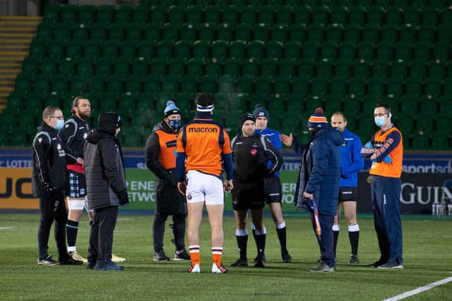 Coaches, captains and match officials discuss the state of the Scotstoun pitch before the Glasgow Warriors v Edinburgh match was called off. Picture: Alan Harvey/SNS