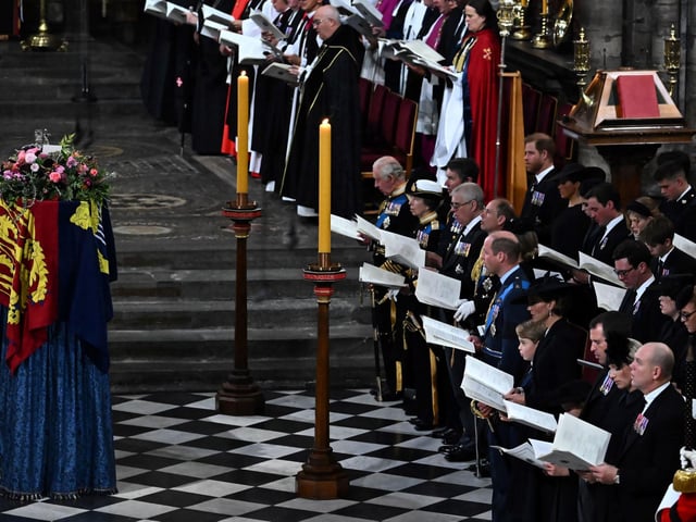 The coffin of Queen Elizabeth II, draped in a Royal Standard and adorned with the Imperial State Crown and the Sovereign's orb and sceptre lying at her State Funeral. Ben Stansall/PA Wire