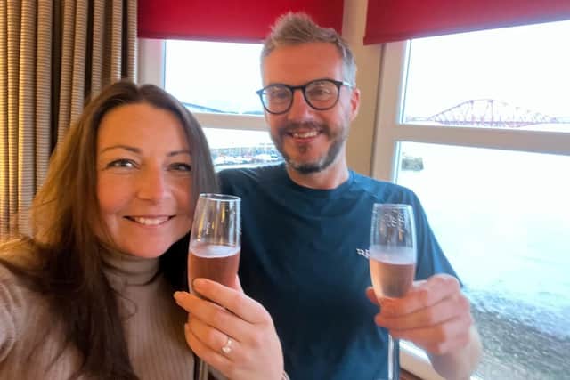 Meghan and Paul celebrating with champagne after the proposal in South Queensferry/