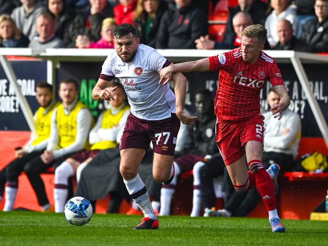 Robert Snodgrass battles with Aberdeen's Ross McCrorie during the home side's 3-0 win over Hearts at Pittodrie this past weekend. Picture: SNS
