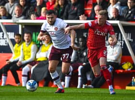 Robert Snodgrass battles with Aberdeen's Ross McCrorie during the home side's 3-0 win over Hearts at Pittodrie this past weekend. Picture: SNS