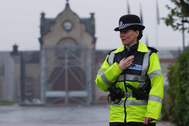 A policewoman controls access to Saughton Prison in 2002  where a disturbance broke out in Glenesk Hall after a dispute over visiting rights.