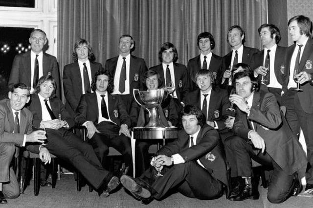 The Hibs squad with manager Eddie Turnbull, front extreme left, celebrate with the trophy