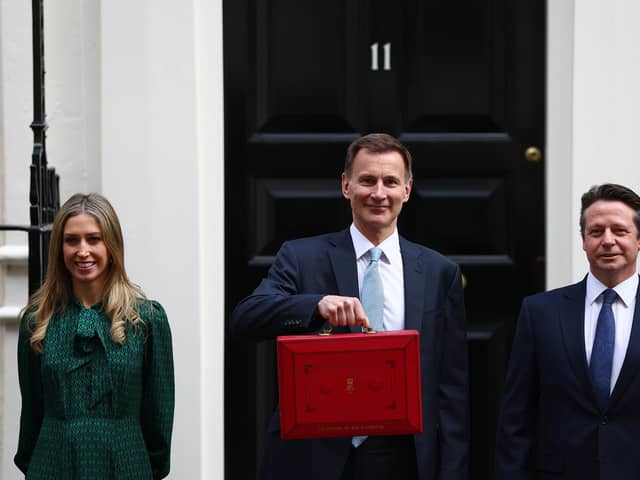 Chancellor Of The Exchequer Jeremy Hunt poses with members of the Treasury staff as he leaves 11 Downing Street to deliver the Budget