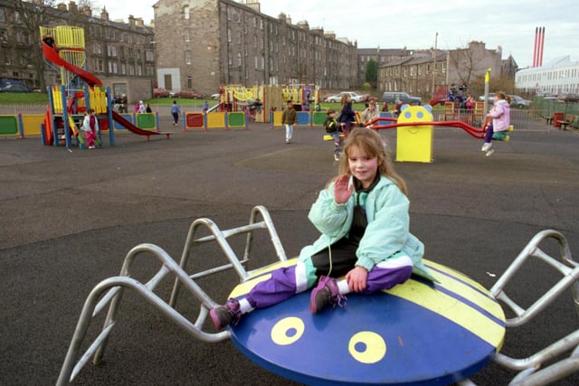 A ittle girl waves to the photographer from one of the climbing frames at the newly-refurbished playground in Edinburgh's Montgomery Street in December 1990.