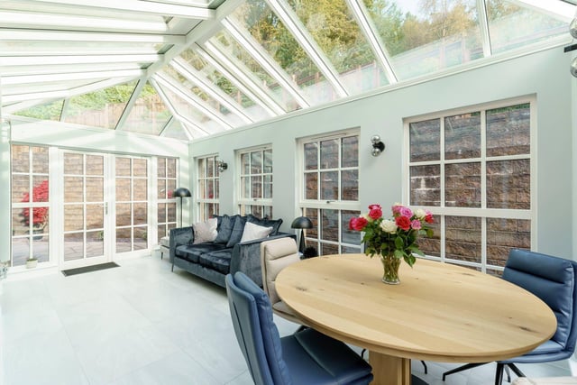 The Balerno property benefits from this stunning sunroom, which brings natural light flooding into this luxury family home, and has underfloor heating.