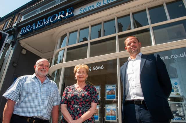 CEO of Braemore Andrew Seldon (wearing jacket) with Broughton Property Management vendors, Isobel Young and Duncan McDonald. Picture: Simon Williams