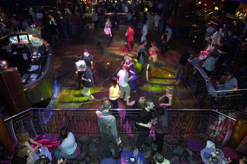 Office-party revellers dance at the Revolution Club on Lothian Road, Edinburgh; June 29, 2001.