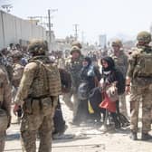Members of the British and US military engaged in the evacuation of people out of Kabul, Afghanistan.