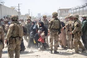 Members of the British and US military engaged in the evacuation of people out of Kabul, Afghanistan.