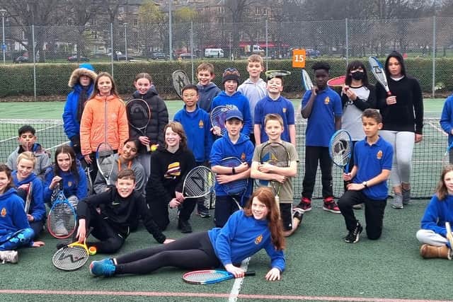 Illustrating commitment to junior tennis at the Meadows club are a group of Sciennes Primary youngsters with Blane Dodds, Tennis Scotland chief executive pictured left while Alex Harkins (coach) is centre when David Rawlinson, LTA president, paid a visit