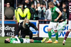 Drey Wright receives treatment before limping off late in the first half. He had got Hibs off to a flyer