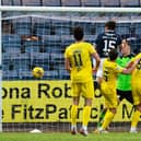 Josh Mulligan heads Dundee back in front against Hibs at Dens Park. Picture: SNS