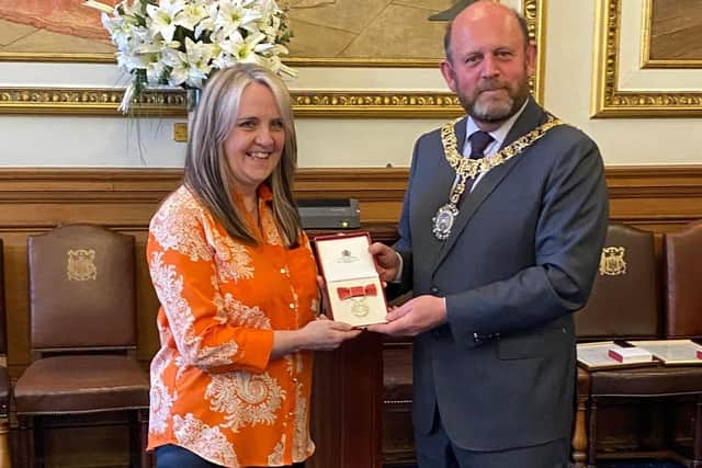 Edinburgh musician Kirsty Baird, pictured receiving her BEM in 2021 at the City Chambers from then Lord Provost Frank Ross, will attend the Coronation of King Charles on Saturday.