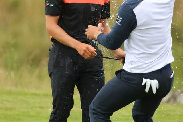 Grant Forrest is showered by compatriot Calum Hill on the 18th green at Fairmont St Andrews. Picture: Andrew Redington/Getty Images.
