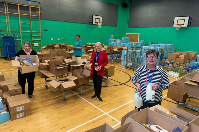 Volunteers packing food parcels at Craigroyston High School for distribution around the city.