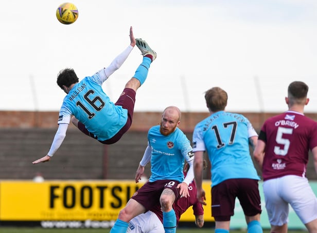Hearts midfielder Andy Halliday rises above the rest as team-mate Liam Boyce holds off the Arbroath players.